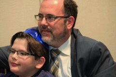 Rabbi David Fine and his son enjoying Betsy Teutsch's presentation about global tikkun olam
