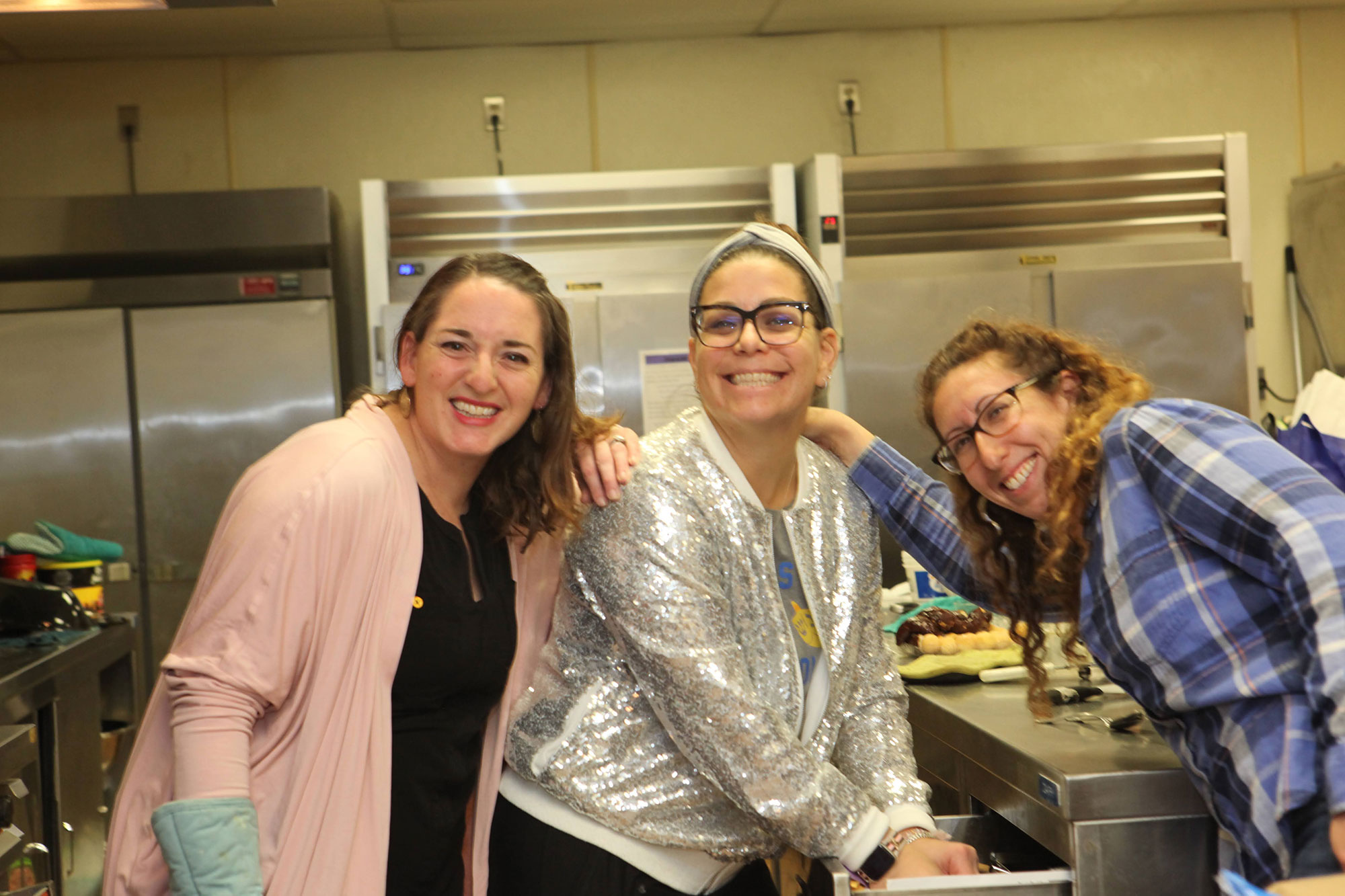 Three women from Sisterhood in the temple's kitchen